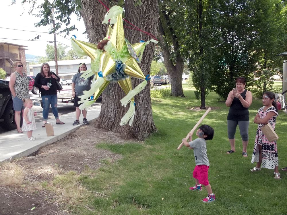 child playing with a pinata